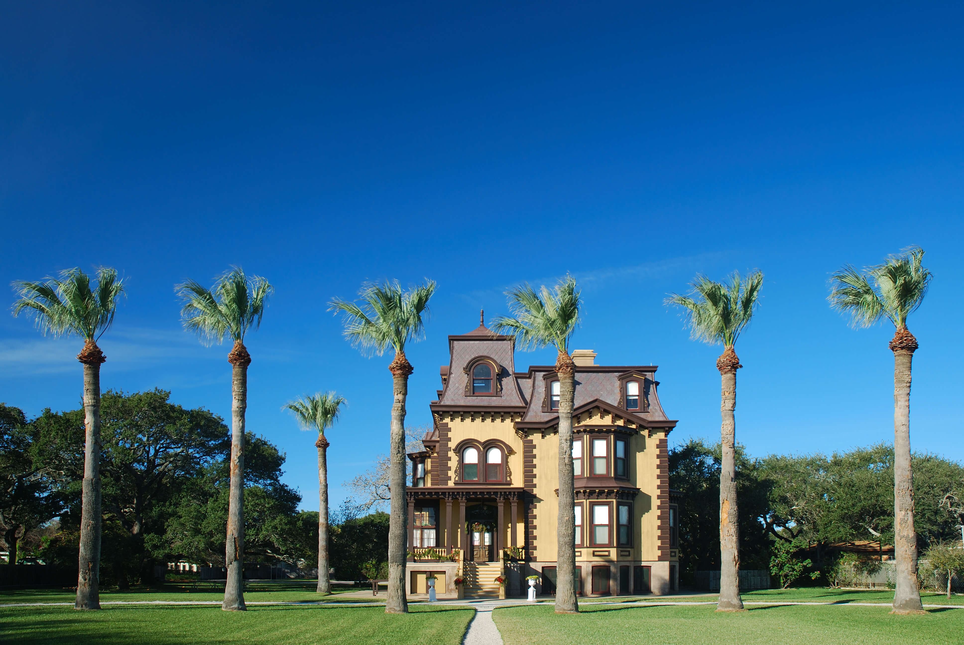 Exterior view of Fulton Mansion with palm trees
