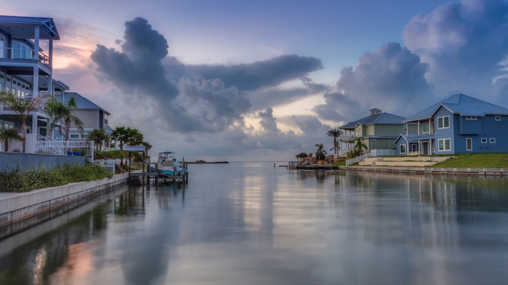 Waterfront properties at dusk with clouds reflecting off water